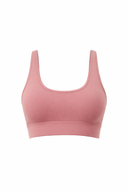 Pink sports bra on a white background